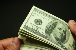 hands holding stack of 100 bills shutterstock_480869