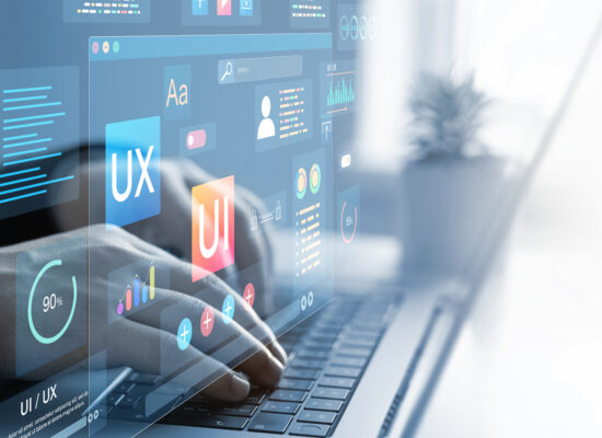 Designer typing on laptop with UI/UX dashboard overlays, app analytics, and wireframe icons for user experience design